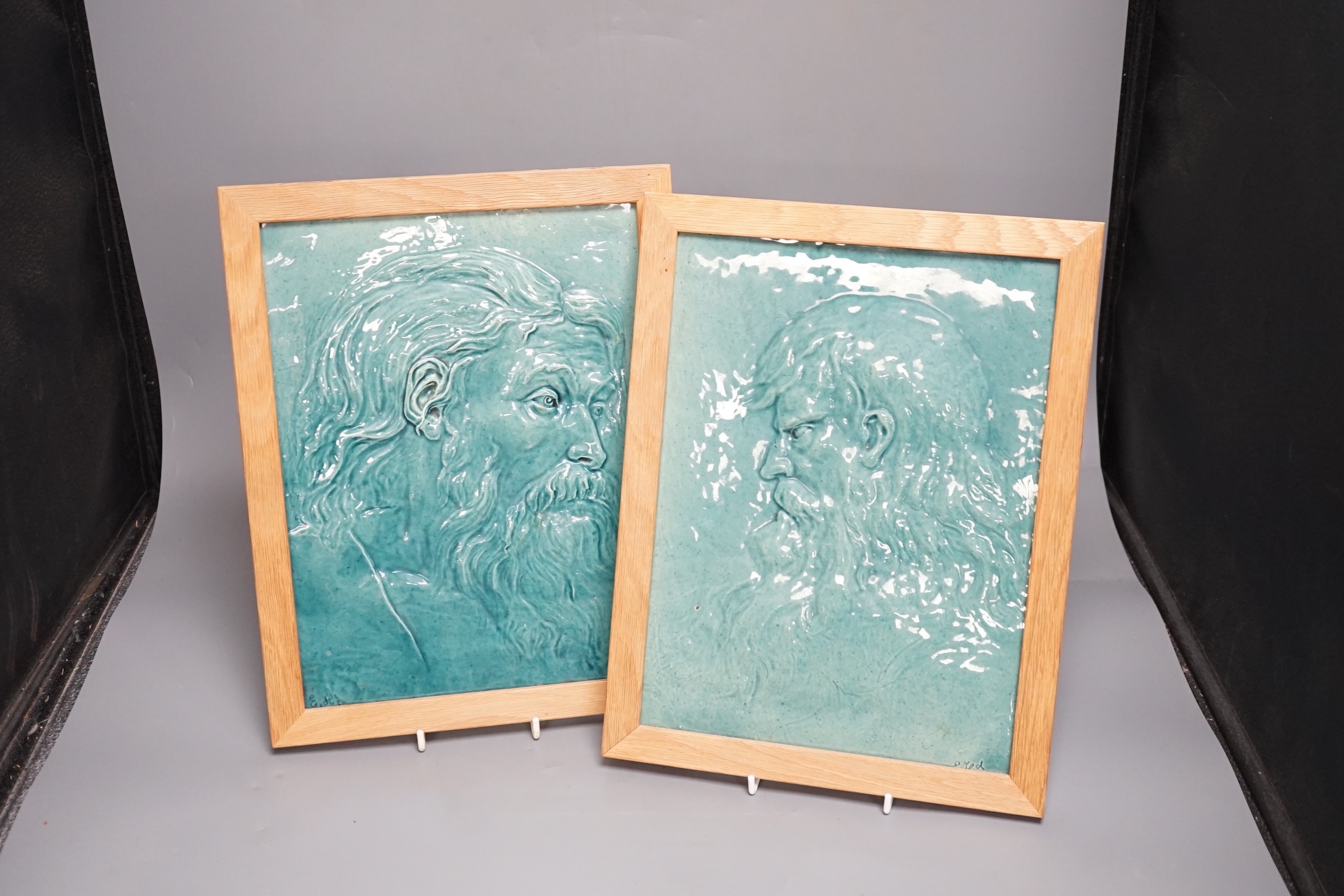 A pair of Burmantofts relief-moulded turquoise glazed portrait plaques, late 19th century, modern oak frames. 30x23cm